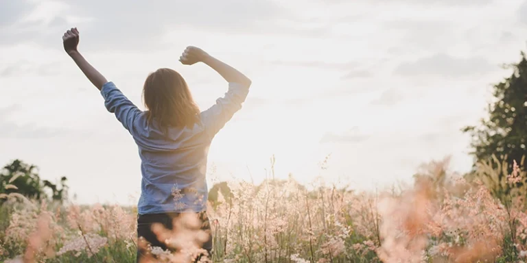 spring - 4 Plumbing Tips to Kick Off Your Spring Right - happy woman in field of flowers