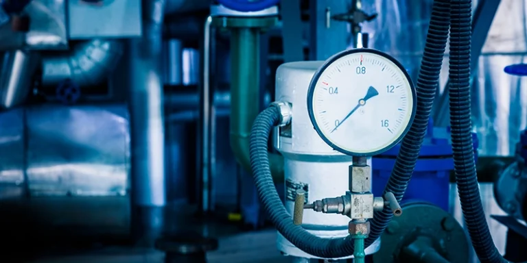 sump pump - How to Stay Dry… by Keeping Your Sump Pump Clean - view of pump with pressure guage