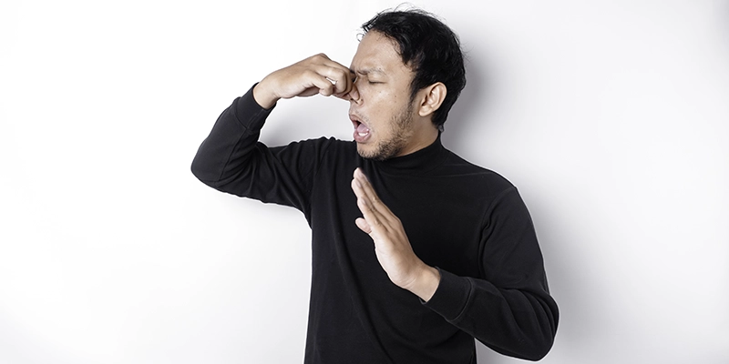 sewer smells - Are Stinky Sewer Smells Wafting Out of Your Drains? - man holding nose