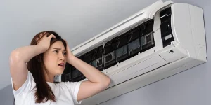 air conditioner - 3 Reasons Your Air Conditioner Needs a Tune-Up - distressed woman with open air conditioner