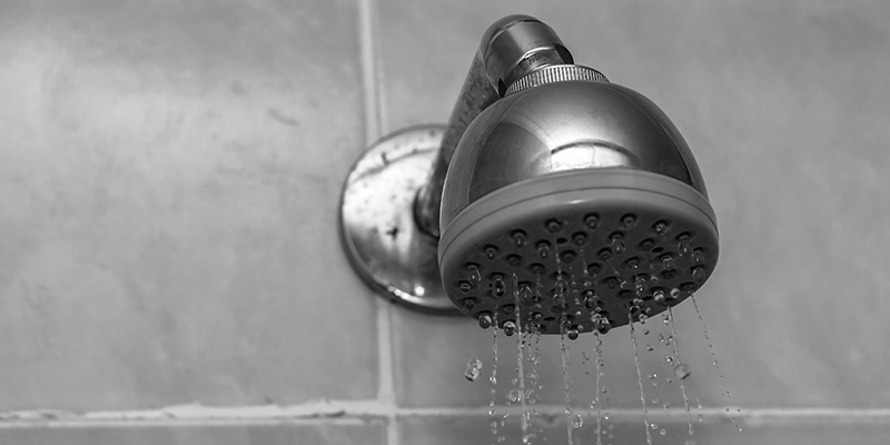shower valves - Types of Shower Valves Explained - showerhead with water dripping down