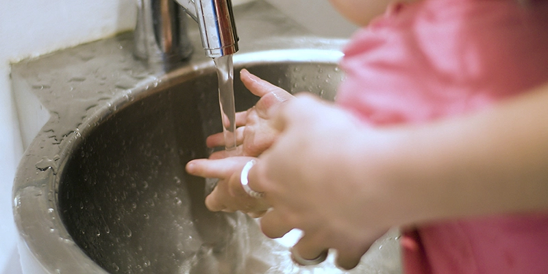 low water pressure - Water flow from faucet - person helping baby wash hands in sink