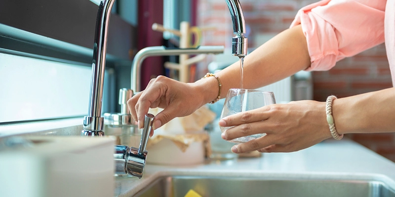 water hardness - Causes of Water Hardness in Las Vegas - putting water into cup from a faucet