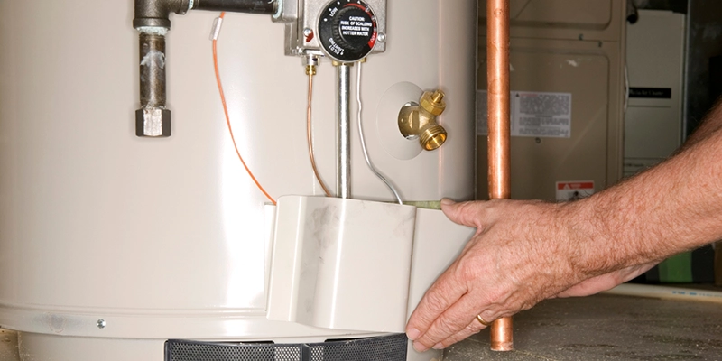 water heater - Does the water heater have a warranty- plumber adjusting water heater
