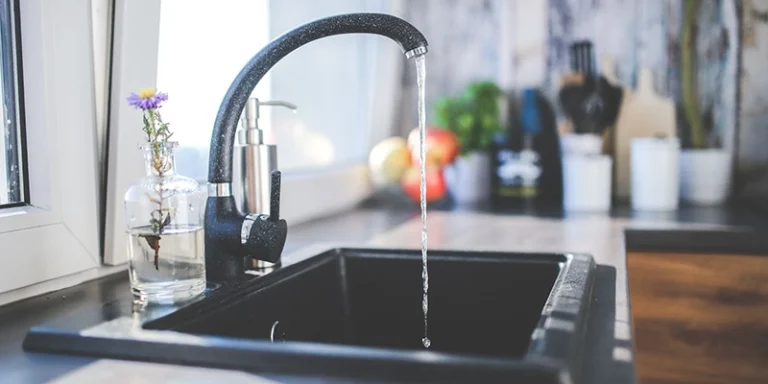 water filtration - flowing water from black faucet