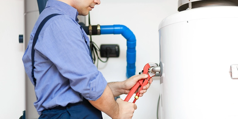 water heater - Call a Plumber for Water Heater Repair - plumber with large industrial water heater
