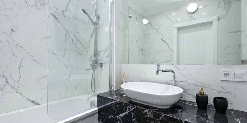 increase water pressure - Six Tips to Increase Water Pressure in Your Shower - bathroom with marble walls and white sink