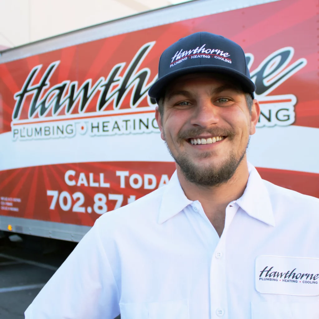 Hawthorne PHC About Us - Image of Hawthorne's Truck with technician smiling in front of truck