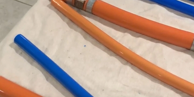 kitec plumbing - How to Tell if You Have Kitec Pipes Installed in Your Home - blue and orange kitec pipes on floor
