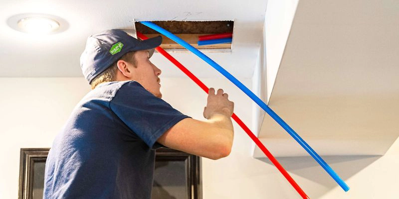 kitec plumbing - Plumbing contractor fixing Kitec plumbing problems - plumber with kitec pipes in ceiling