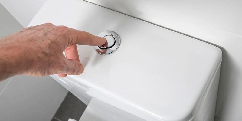 weak flush - Incomplete Flush - man pushing toilet flush button