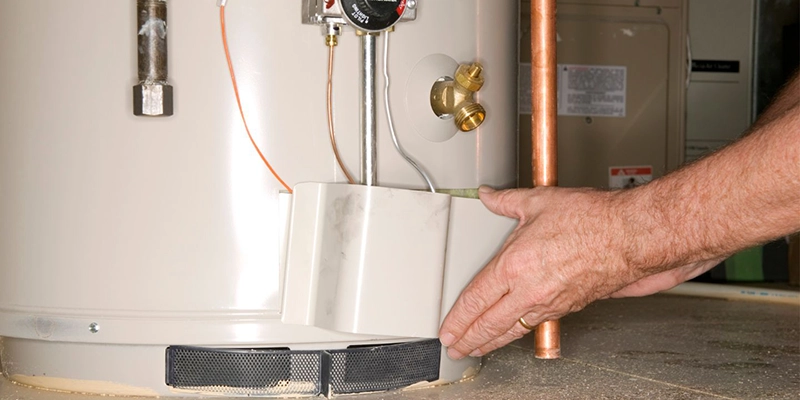 water heaters - Signs That You Need to Replace Your Water Heater - person moving water heater part