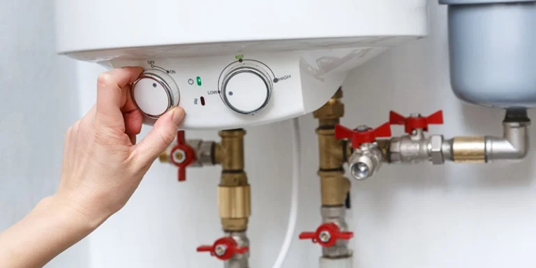 water heaters - Hot water heaters - person adjusting water heater controls